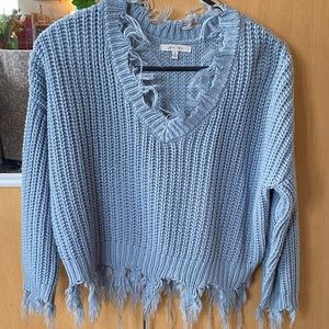 medium cropped blue sweater. distressed